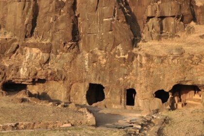 The image is of the Lohani Caves in Madhya Pradesh, featuring a large cave entrance.