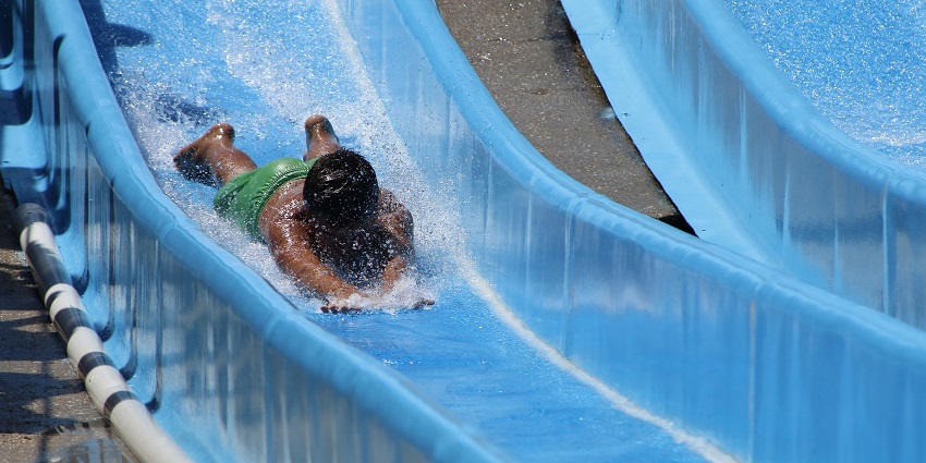 A view of children enjoying a water slide at the top waterpark in Lonavala and having fun.