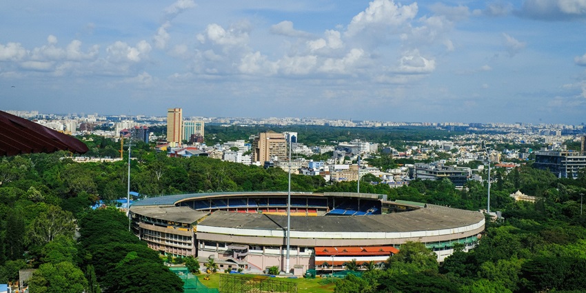 An aerial view of M Chinnaswamy Stadium surrounded by majestic buildings and houses.