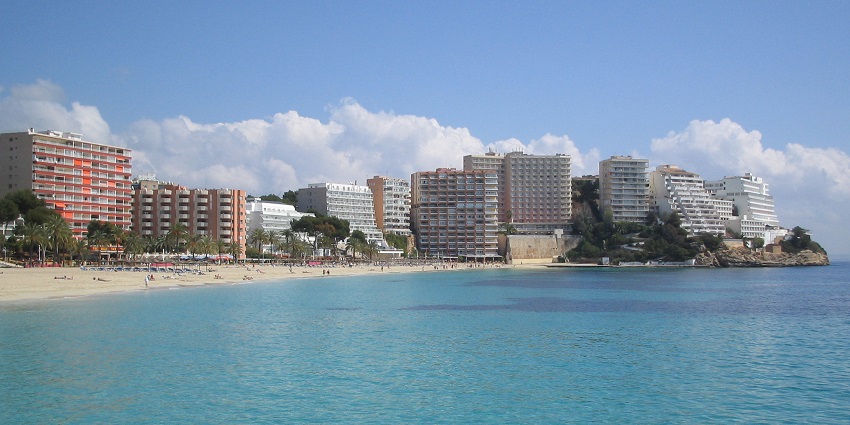 A picture of a scenic resort with tranquil views of the blue ocean and golden beach