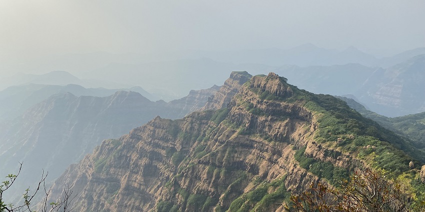 Beautiful view of Mahabaleshwar landscape featuring rolling hills and a clear sky.