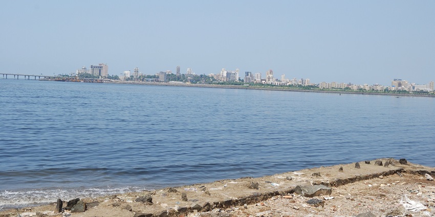 Scenic view of the beach overlooking the city far away