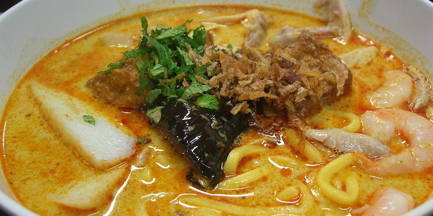 Laksa, A chilli-laced coconut broth packed with seafood and noodles - the best food in Pune.