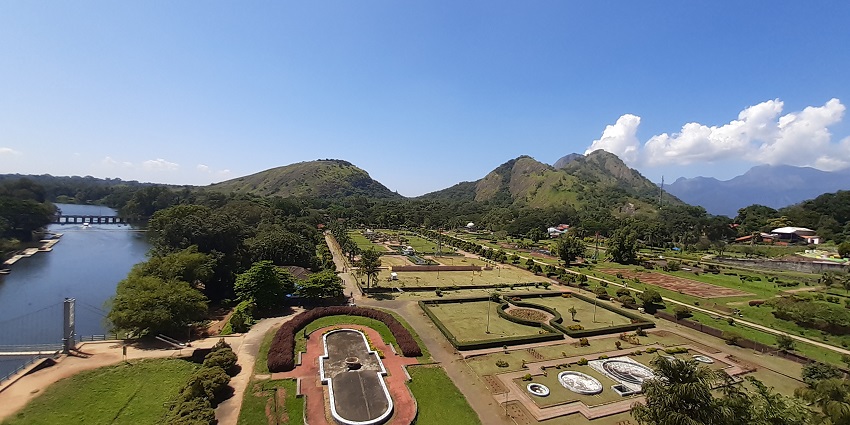 Serene dam surrounded by gardens, ideal for picnics.
