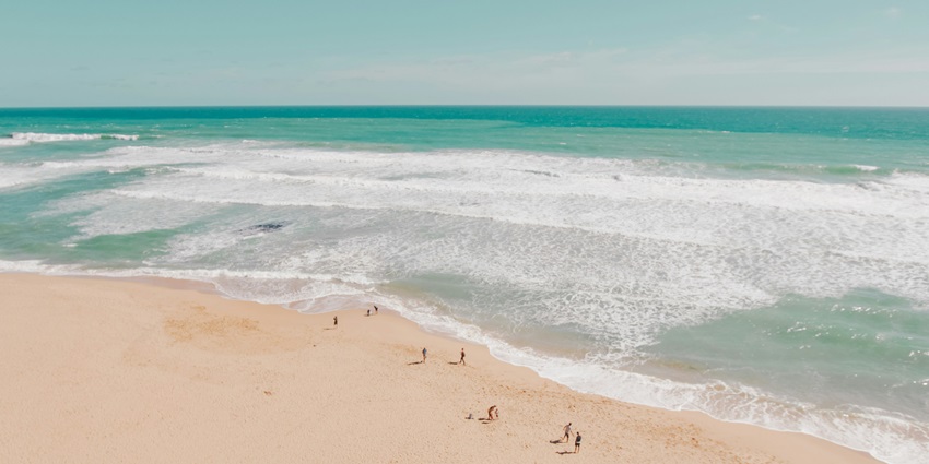 A picture of Malgund Beach with golden sand, and a serene ambience perfect for relaxation.