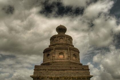 A view of Malhargad Fort, a scenic tourist attraction in Maharashtra, atop rugged terrain.