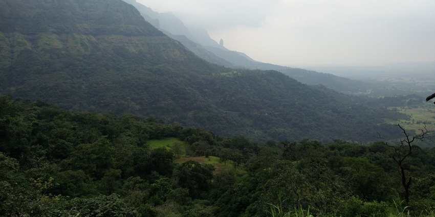 Panoramic view of Malshej Ghat, showcasing the green valleys and mist-covered hills.