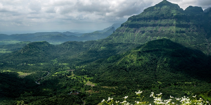 An image of Malshej Ghat, the stunning mountain pass with waterfalls and lush greenery.