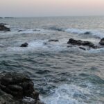 A picture of rapidly flowing water off the rock garden in Malvan.