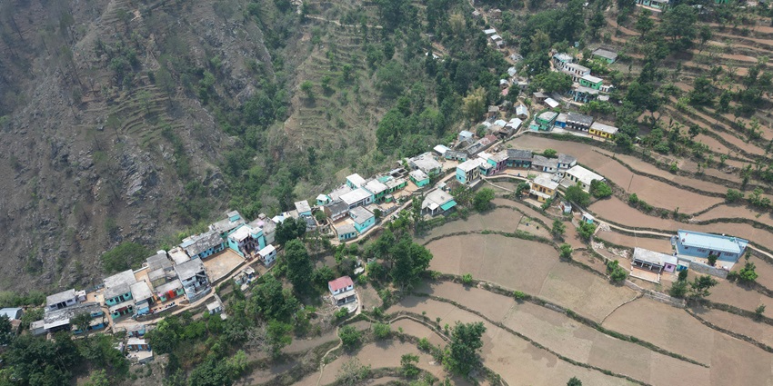 An aerial view of the Manchar village featuring a quaint town and lush greenery.