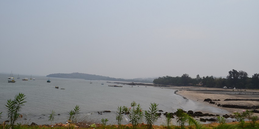 Scenic view of Mandwa Beach with golden sand, clear blue waters, and vibrant beach activities