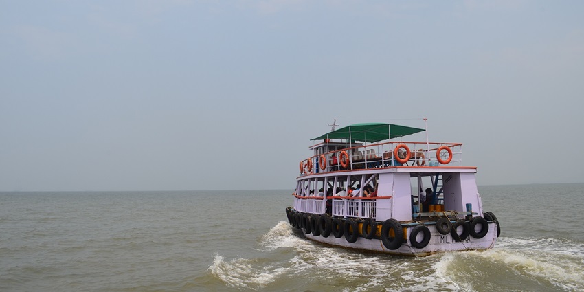 Ferry transporting vehicles and passengers at Mandwa Jetty in Maharashtra, India.
