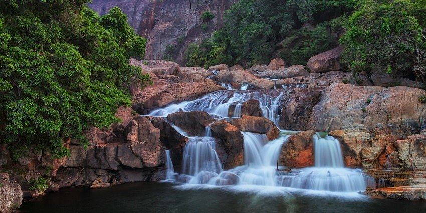 Find your calm in the cascade of Manimuthar Waterfalls, a scenic wonder in Pothigai Hills.