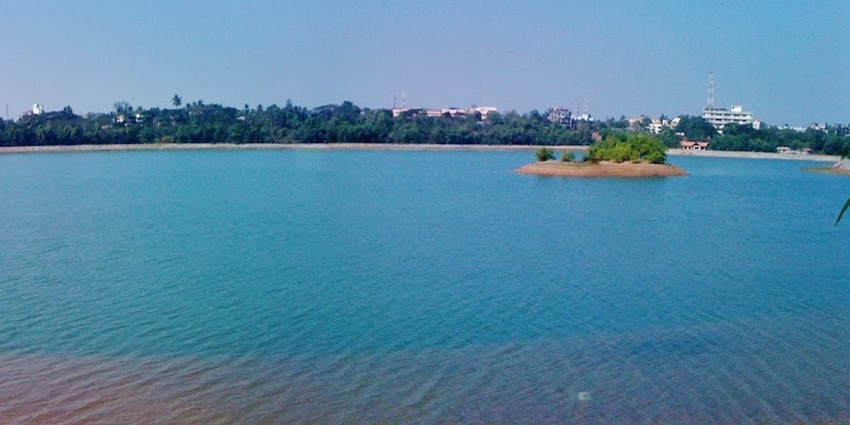 Peaceful view of Manipal Lake with calm waters and a serene atmosphere.