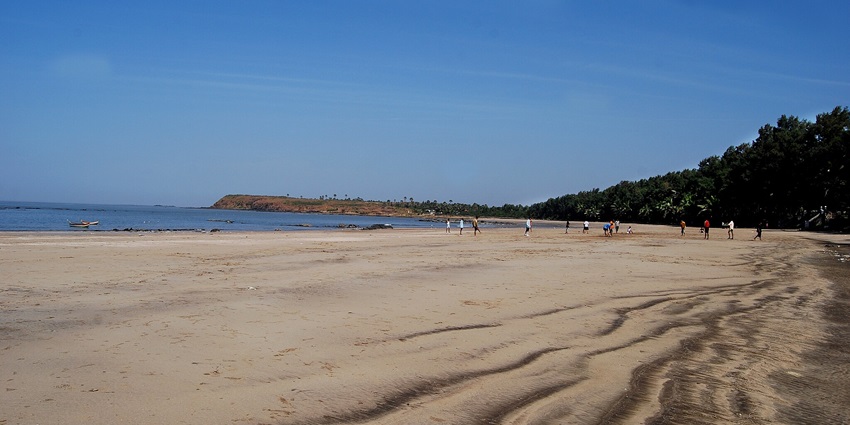 A picture of Manori Beach where two people are standing, a hidden gem near Thane