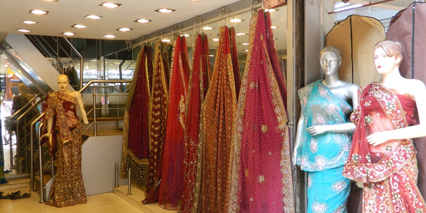 A picture of a premium wedding shopping store in Dadar, Mumbai with bright sarees on display
