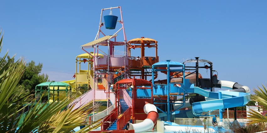 An image of Toddler swimming in a pool and splashing around