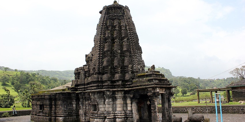 Stone-carved Amriteshwar Temple with intricate architecture surrounded by greenery and hills–places to visit in jalgaon