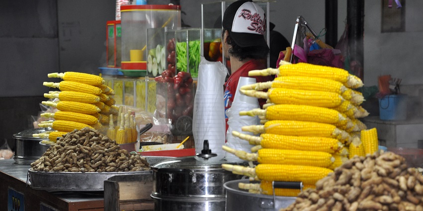 Vibrant stalls offering local snacks and seafood by the beach