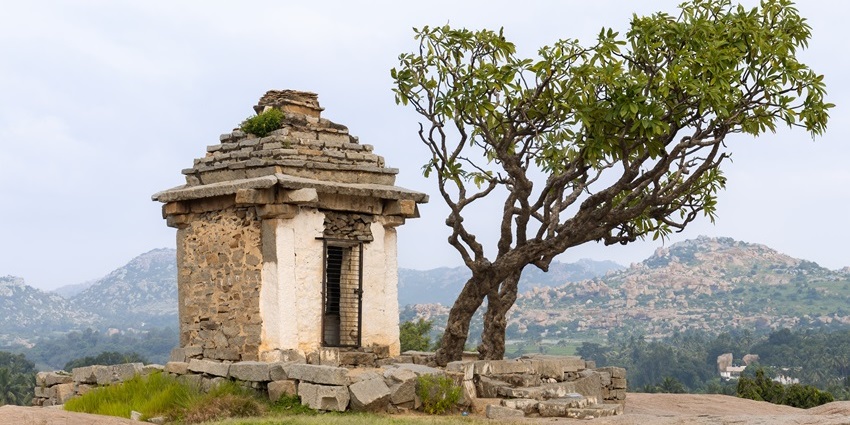 A historical temple perched on top of a lush green hill near Kolar