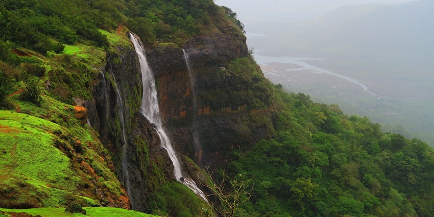 Enchanting Matheran Waterfall cascading through lush greenery in Matheran Hills.