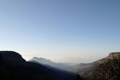 A breathtaking vista majestic peaks decked with lush green vegetation in Maharashtra.