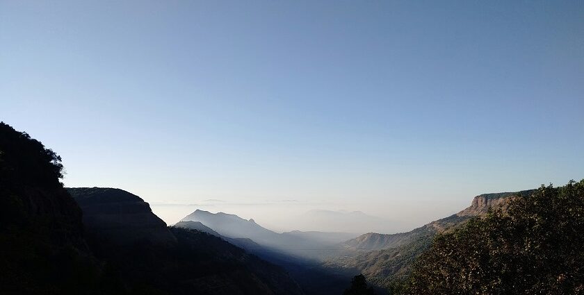 A breathtaking vista majestic peaks decked with lush green vegetation in Maharashtra.