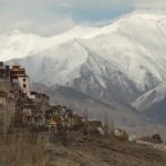 Panoramic view of the Matho monastery with snow covered peaks in the background