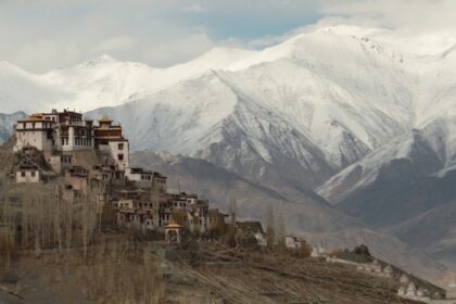 Panoramic view of the Matho monastery with snow covered peaks in the background