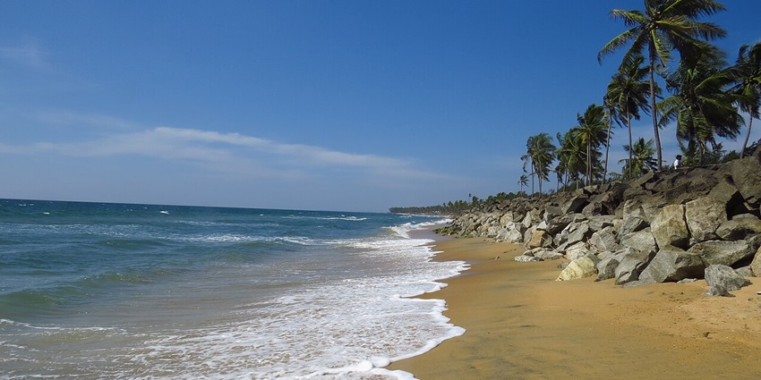 Waves crashing the sandy shores of Mattu Beach offering a beautiful coastal view