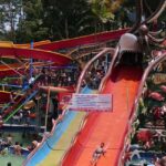 A vibrant view of Mauli Water Park Shegaon showcasing various water slides, pools, and families enjoying their day.