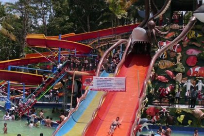 A vibrant view of Mauli Water Park Shegaon showcasing various water slides, pools, and families enjoying their day.