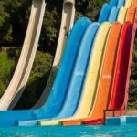 A vibrant view of Mohini Water Park showcasing colourful slides ends in water pools.