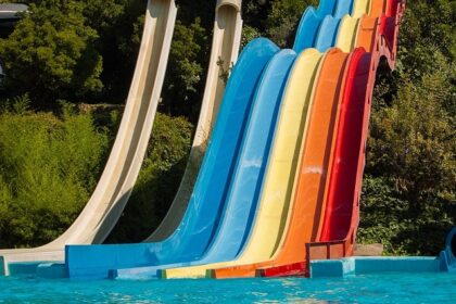 A vibrant view of Mohini Water Park showcasing colourful slides ends in water pools.