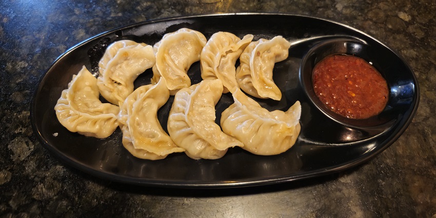 Eight crescent shaped steamed momos, among the best street food in Koregaon Park.