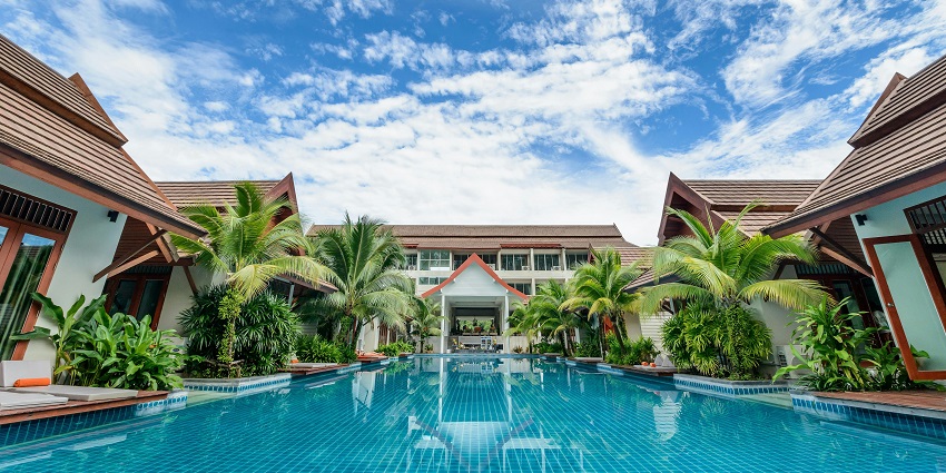 Monteria resort beautiful body of water reflecting nearby buildings, creating a tranquil scene.