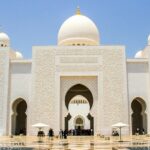 A picture of a traditionally built prayer house for the Muslim people with white walls and domes