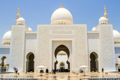 A picture of a traditionally built prayer house for the Muslim people with white walls and domes