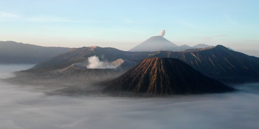 Mount Bromo at sunrise, showing its volcanoes and Mount Semeru in the background