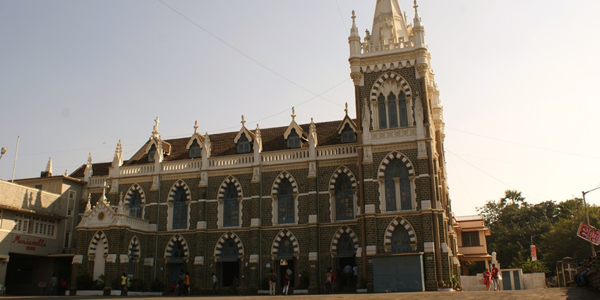 Image of Mount Mary's Bascillica, Mumbai with crowd strolling around the street