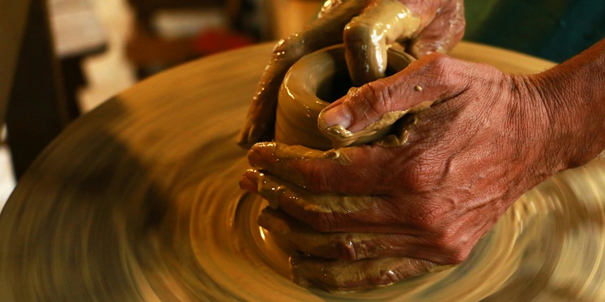 Watch an older man skillfully crafting pottery in his workshop, preserving timeless art.