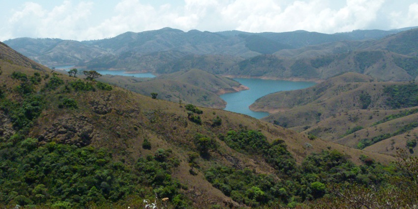 A majestic view of the vast hills at the Mukurthi National Park with a water body in the middle