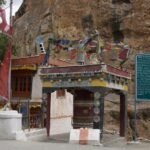 Full view of Mulbekh Monastery, showcasing its unique architecture and mountains.