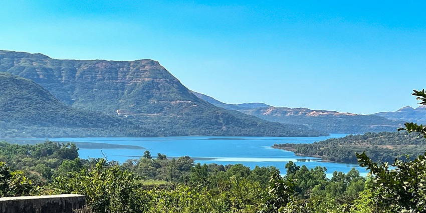 Scenic view of Mulshi Lake with greenery and hills surrounding it, one of the best places.