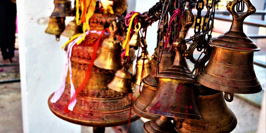 A picture of sacred bells hanged at the entrance of a historical temple in Maharashtra