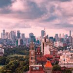 Mumbai skyline during monsoon with tall buildings and cloudy sky, seen from Malabar Hill.