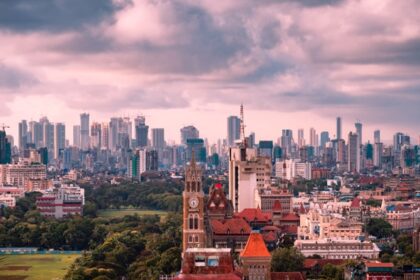 Mumbai skyline during monsoon with tall buildings and cloudy sky, seen from Malabar Hill.