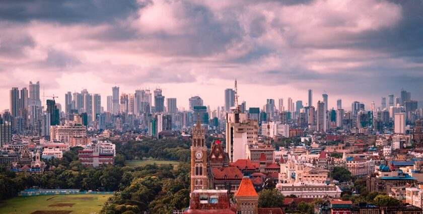 Mumbai skyline during monsoon with tall buildings and cloudy sky, seen from Malabar Hill.