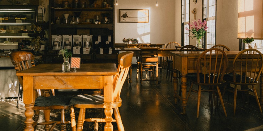 Cozy Japanese-style café interior at sunset with warm lighting, wooden décor, and seating