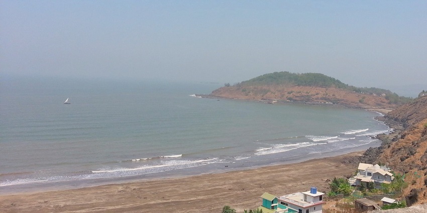 A breathtaking view of Murud Beach with soft sands and gentle waves under a clear sky.